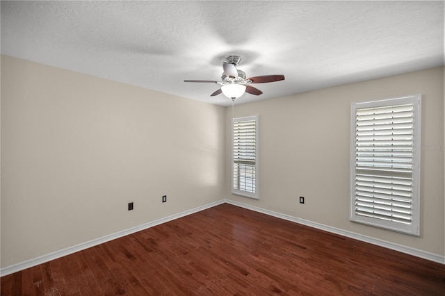 unfurnished room with ceiling fan and dark hardwood / wood-style flooring