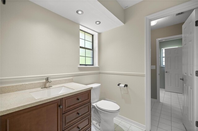 bathroom featuring tile patterned floors, vanity, and toilet