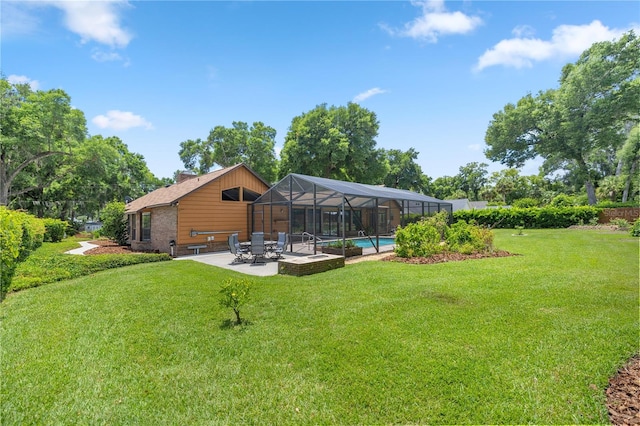 view of yard featuring a patio and glass enclosure