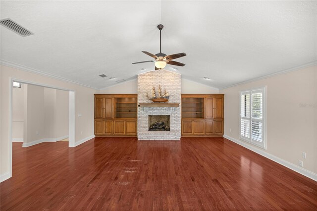 unfurnished living room with ornamental molding, ceiling fan, dark hardwood / wood-style floors, a fireplace, and lofted ceiling