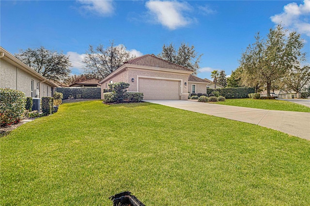 view of front of house featuring a garage and a front lawn