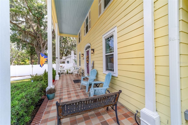 view of patio with a porch and fence