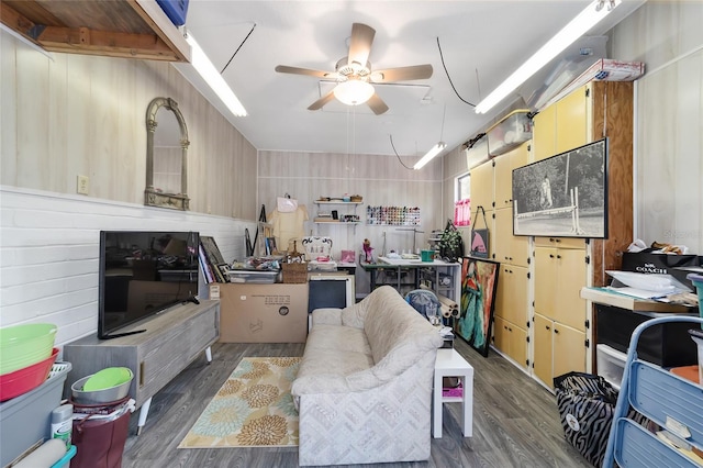 living room featuring ceiling fan and dark wood-type flooring