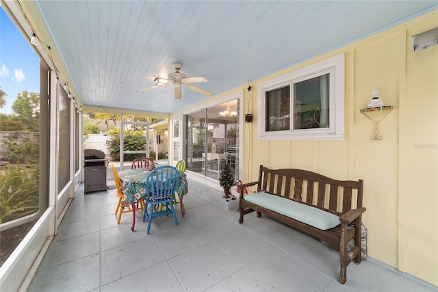 sunroom / solarium with ceiling fan and wooden ceiling