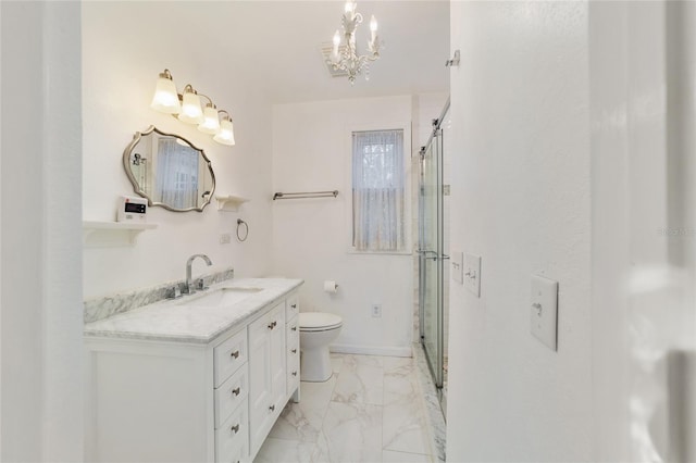 bathroom featuring vanity, a chandelier, an enclosed shower, and toilet