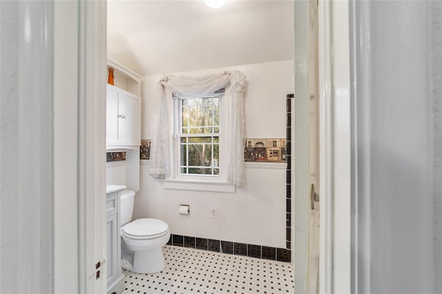 bathroom featuring toilet, tile patterned flooring, and vanity