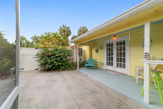 view of patio featuring french doors and fence