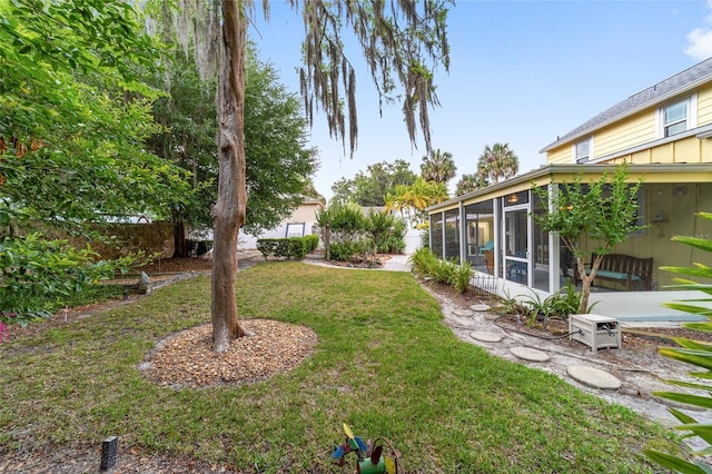 view of yard with a sunroom and fence