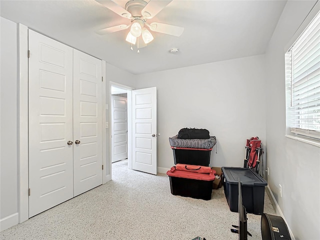 living area with ceiling fan