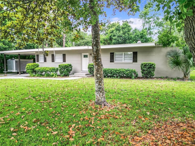 ranch-style house featuring a front yard and a carport