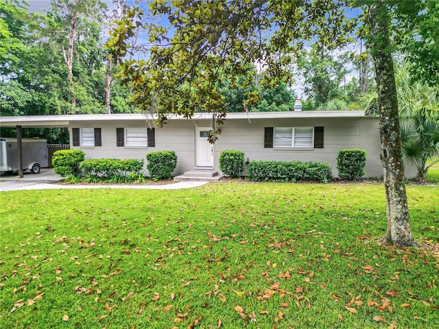 ranch-style home with a carport and a front lawn