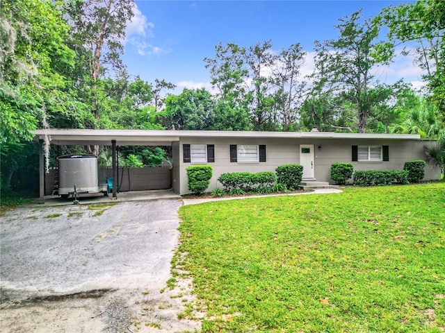 ranch-style home with a front yard and a carport