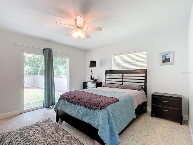 bedroom with access to outside, ceiling fan, and multiple windows