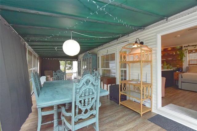 dining space with hardwood / wood-style floors