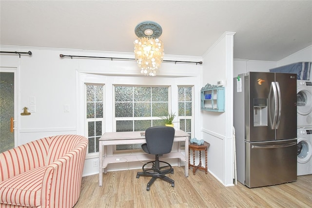 home office featuring a chandelier, light hardwood / wood-style flooring, stacked washer / drying machine, and ornamental molding