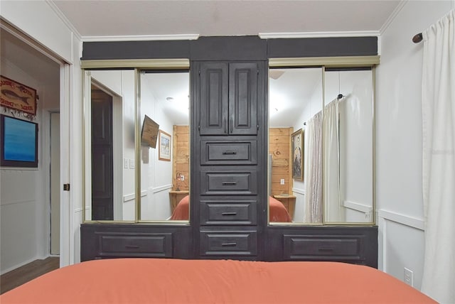 unfurnished bedroom with a closet, crown molding, and wood-type flooring