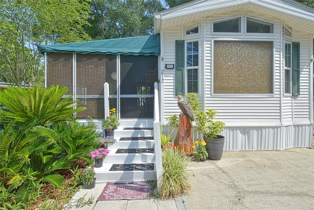 view of exterior entry featuring a patio area