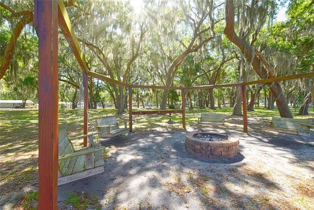 view of home's community with an outdoor fire pit