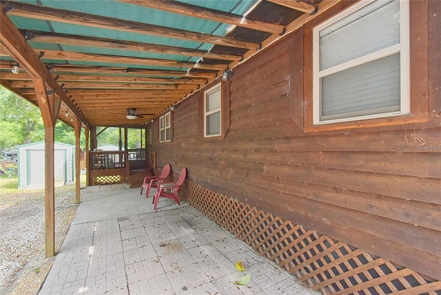 view of patio featuring a storage unit