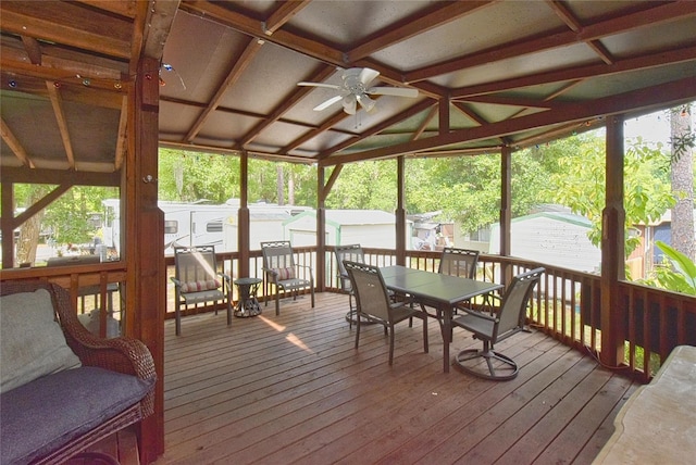 sunroom / solarium with lofted ceiling with beams, ceiling fan, and coffered ceiling