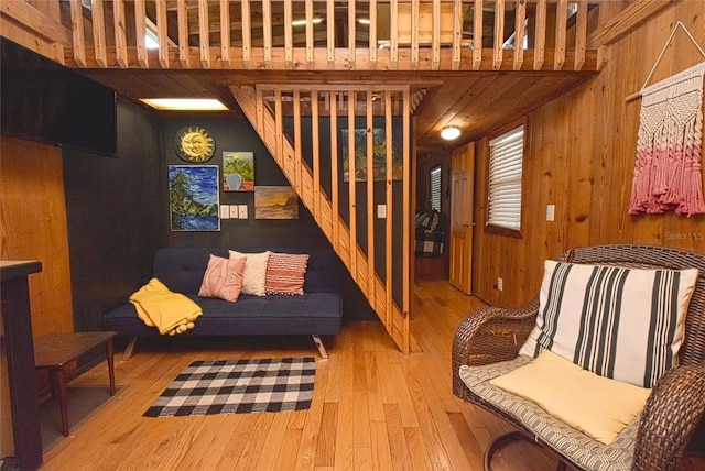 living room featuring wood walls and hardwood / wood-style floors