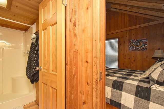 bedroom featuring vaulted ceiling, wooden walls, and wood ceiling