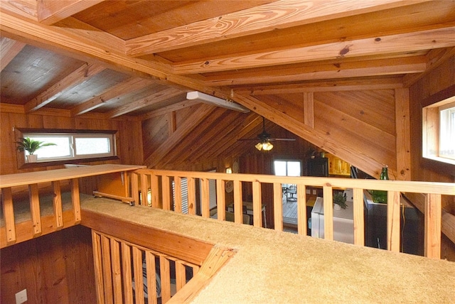 interior space featuring beam ceiling, a healthy amount of sunlight, wooden ceiling, and dark hardwood / wood-style flooring