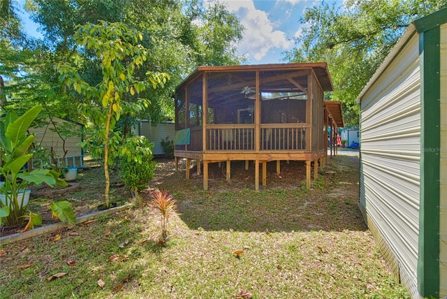 rear view of house featuring a sunroom