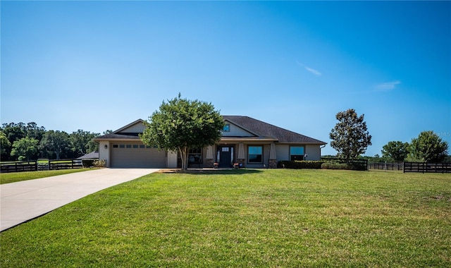 view of front of home with a front yard and a garage