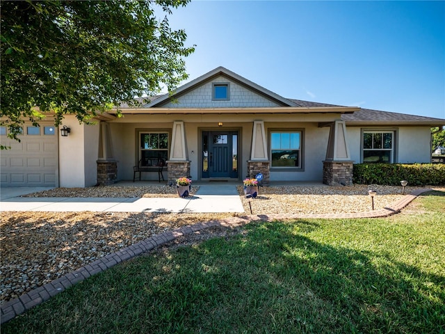 view of front facade with a porch, a garage, and a front yard