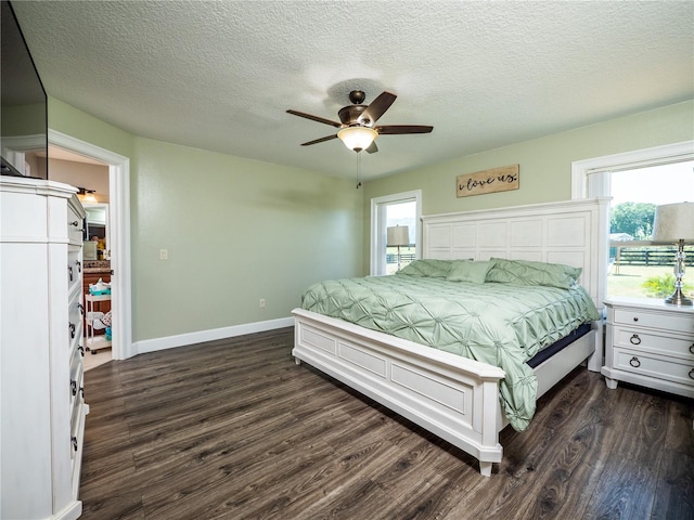 bedroom with dark hardwood / wood-style floors, ceiling fan, and a textured ceiling