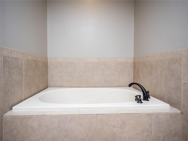 bathroom featuring a relaxing tiled bath