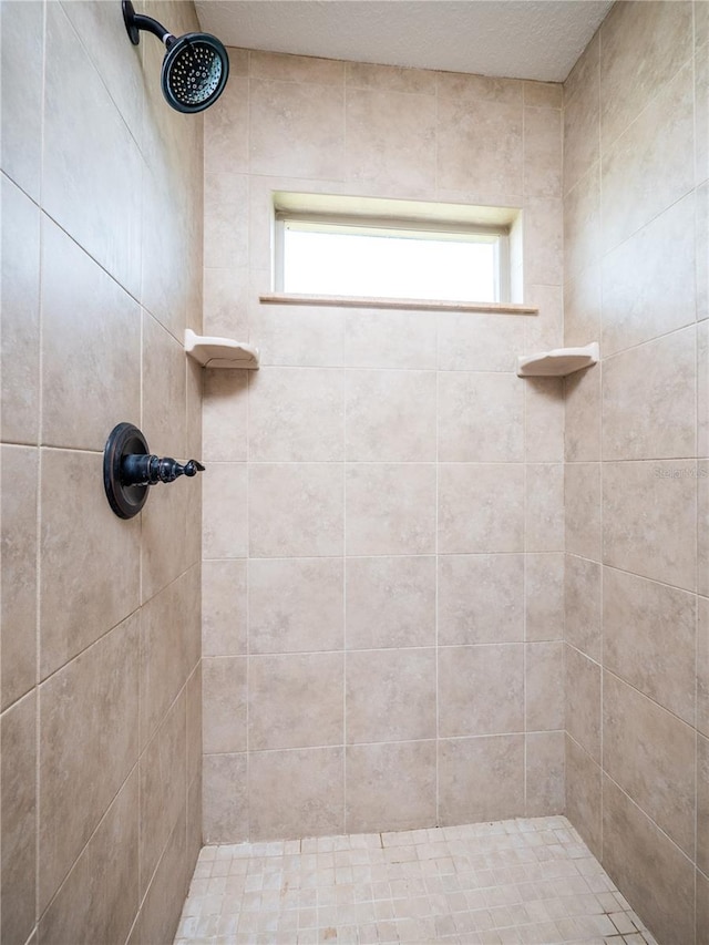 bathroom with tiled shower