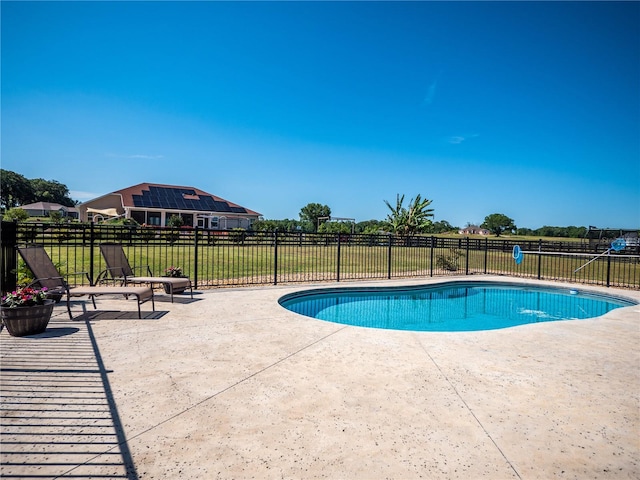 view of pool with a yard and a patio area