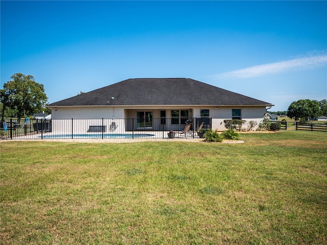 rear view of property featuring a patio and a lawn