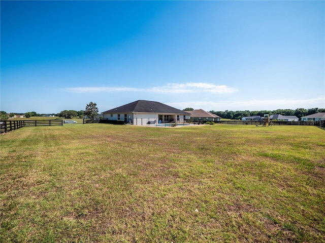 view of yard with a rural view