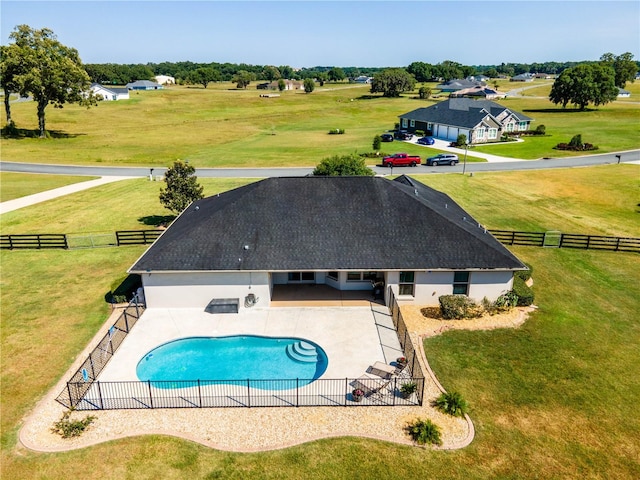 view of pool featuring a rural view, a lawn, and a patio area