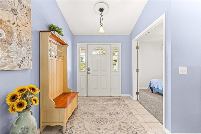 entrance foyer featuring light tile patterned floors and lofted ceiling