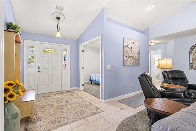 tiled foyer with a wealth of natural light and vaulted ceiling