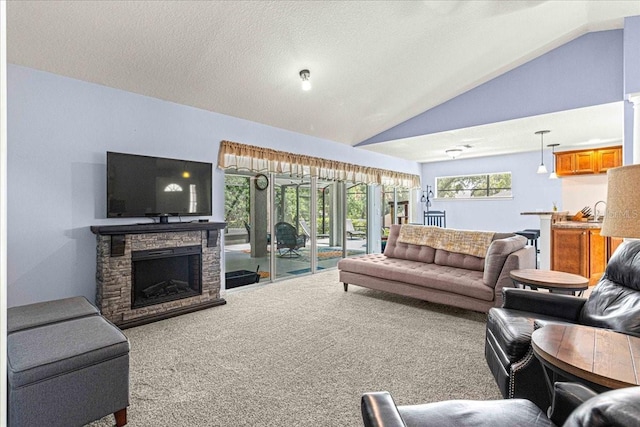 carpeted living room featuring a stone fireplace, a textured ceiling, and high vaulted ceiling