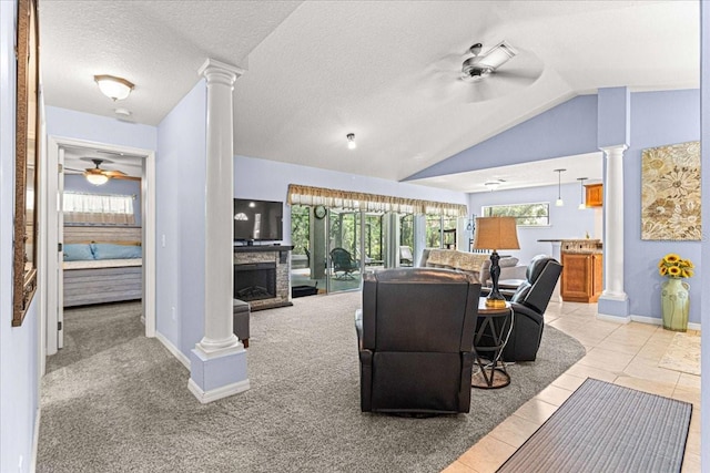 carpeted living room with a textured ceiling, ceiling fan, a fireplace, and vaulted ceiling