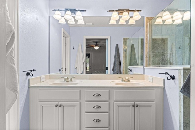 bathroom featuring walk in shower, vanity, and ceiling fan