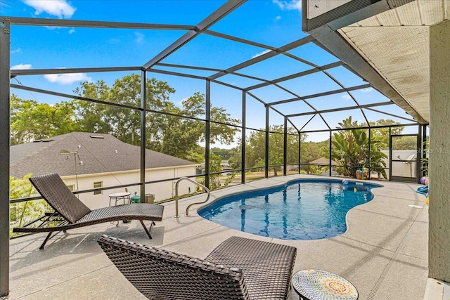 view of swimming pool with a lanai and a patio