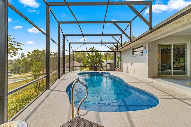 view of swimming pool featuring glass enclosure and a patio