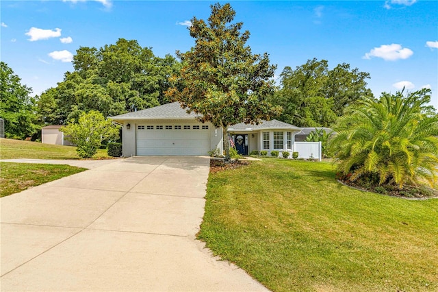 view of front of home with a garage and a front lawn