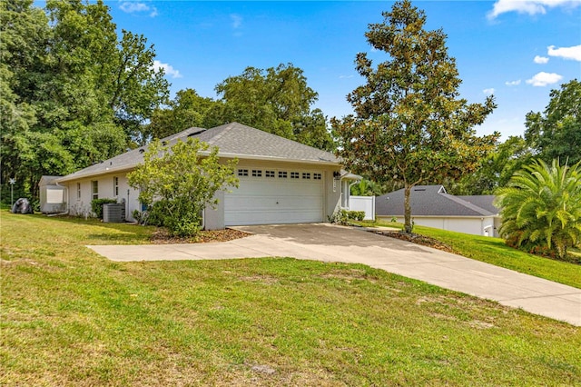 view of home's exterior featuring a garage, a yard, and central AC