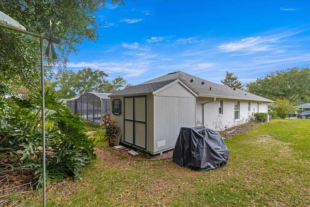 view of outbuilding featuring a lawn