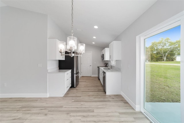 kitchen featuring light hardwood / wood-style flooring, vaulted ceiling, decorative light fixtures, an inviting chandelier, and white cabinets