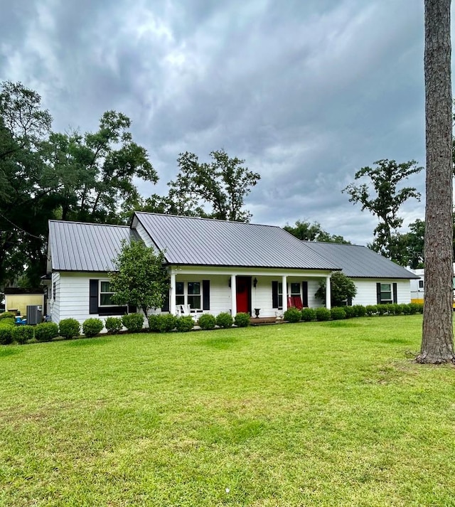 ranch-style home with central AC and a front lawn