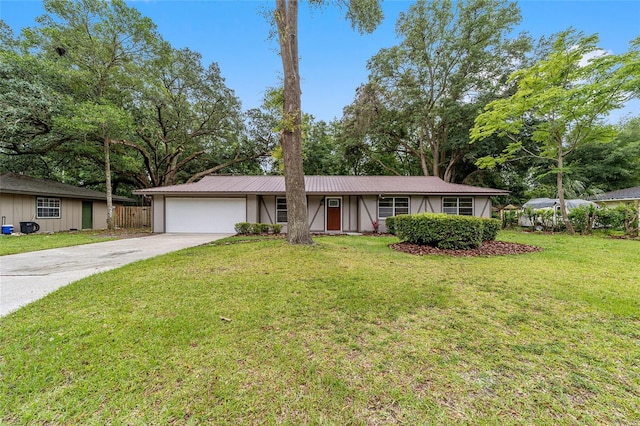 single story home featuring a front yard and a garage